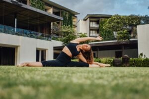 Fitness woman doing yoga exercises inside courtyard