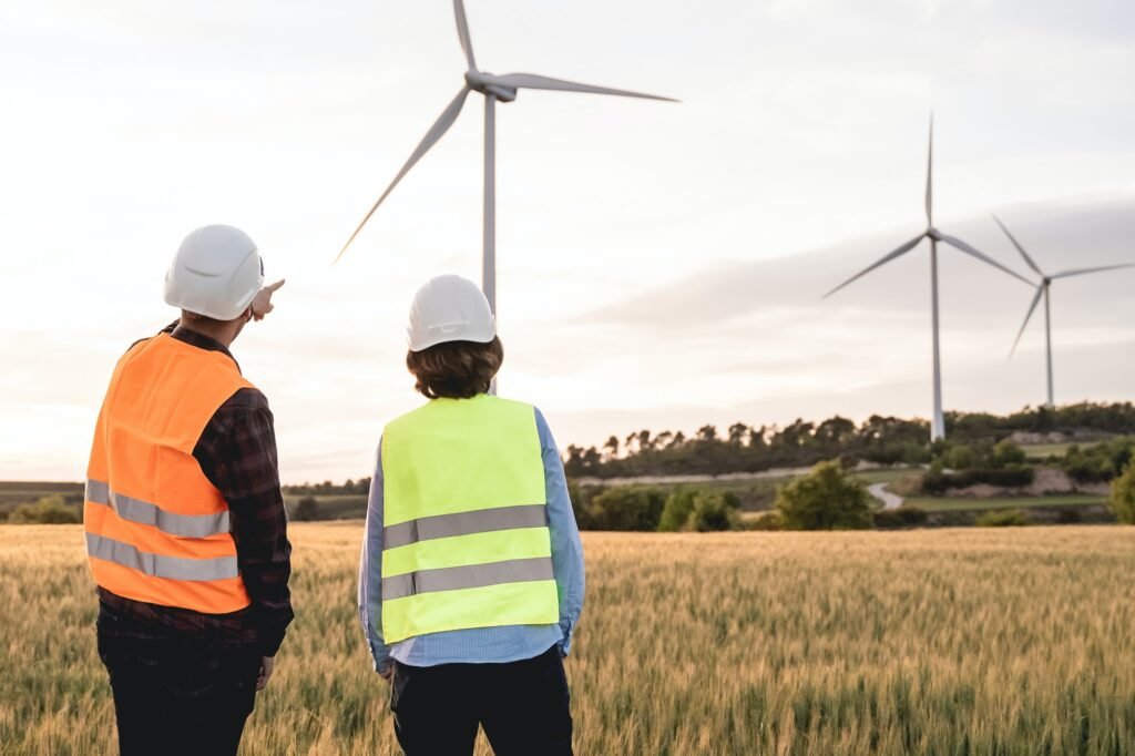 Sustainable energy industry - Engineers working at alternative renewable wind energy farm